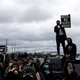 People gather holding signs and flags before curfew to protest the death of Daunte Wright who was shot and killed by a police officer in Brooklyn Center, Minnesota on April 12, 2021.